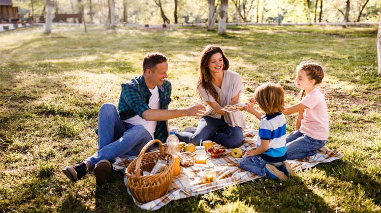 Happy family enjoying a picnic at the park.